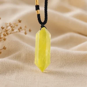 Citrine pendant hanging on silver chain above dark gray suede fabric for elegant jewelry display